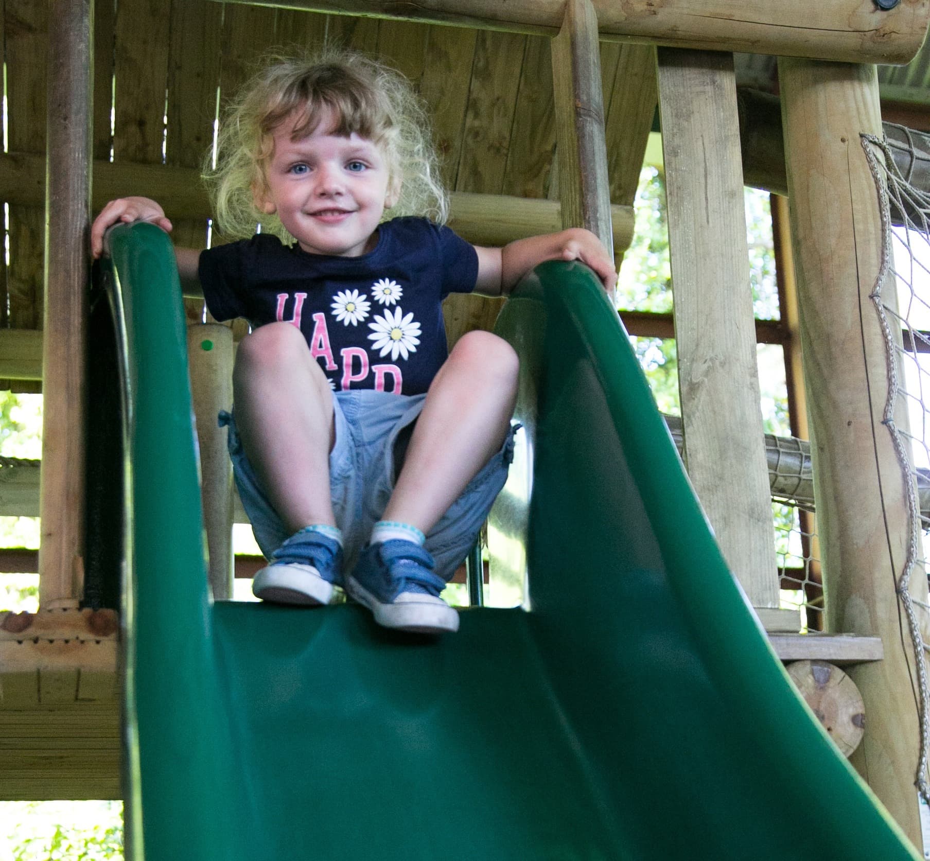 A young child at the top of a slide